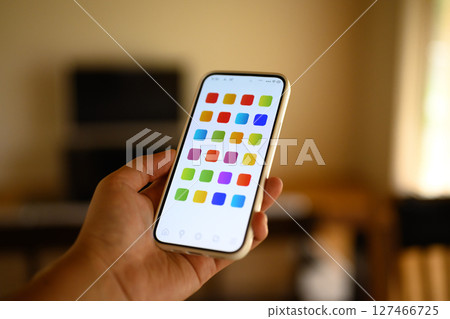 一名男子手持智慧型手機(螢幕是為拍攝而製作的原創畫面) 一名男子手持智慧型手機(螢幕是為拍攝而製作的原創畫面) 127466725