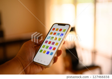 A man holding a smartphone (the screen is an original created for the photo shoot) A man holding a smartphone (the screen is an original created for the photo shoot) 127466838