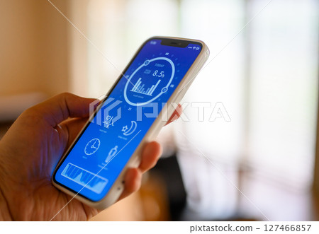 A man holding a smartphone (the screen is an original created for the photo shoot) A man holding a smartphone (the screen is an original created for the photo shoot) 127466857