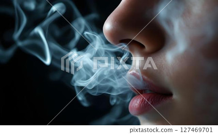 A close-up of a woman's nose with smoke escaping, focusing on the subtle features and the dynamic movement of the smoke 127469701
