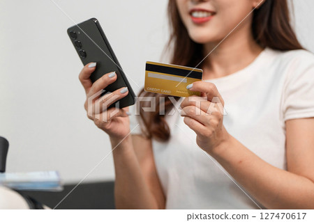 Travel Planning and Preparation. Woman using smartphone and credit card for online booking. 127470617