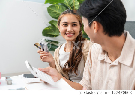 Financial Planning and Budgeting. Couple discussing expenses and managing finances at home. 127470668