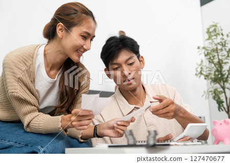 Financial Planning and Collaboration. Couple reviewing financial documents together at home. Financial Planning and Collaboration. Couple reviewing financial documents together at home. 127470677