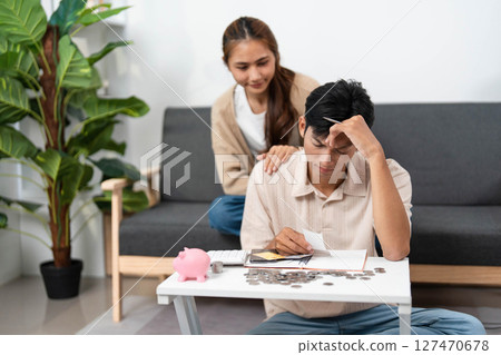 Navigating Financial Stress. Young couple managing expenses with concern. Navigating Financial Stress. Young couple managing expenses with concern. 127470678