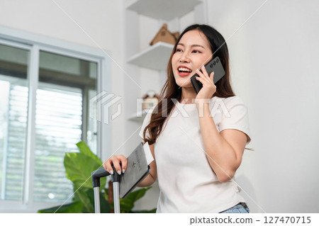 Travel Enthusiast on Call. Woman excitedly planning her journey with smartphone. Travel Enthusiast on Call. Woman excitedly planning her journey with smartphone. 127470715