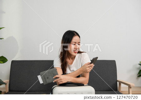 Travel Preparation with Smartphone. Woman excitedly planning her next adventure. Travel Preparation with Smartphone. Woman excitedly planning her next adventure. 127470720