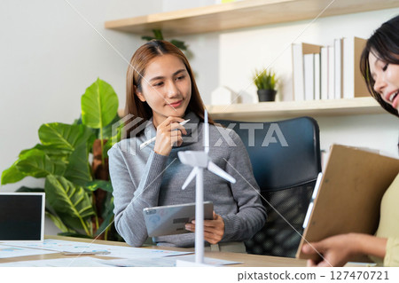 ESG Planning Session. Professionals Analyzing Strategies for Sustainability in Modern Office. ESG Planning Session. Professionals Analyzing Strategies for Sustainability in Modern Office. 127470721
