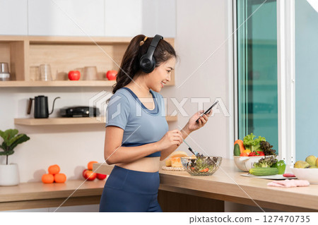 ESG and Wellness. Engaging in a healthy lifestyle while checking a smartphone. ESG and Wellness. Engaging in a healthy lifestyle while checking a smartphone. 127470735