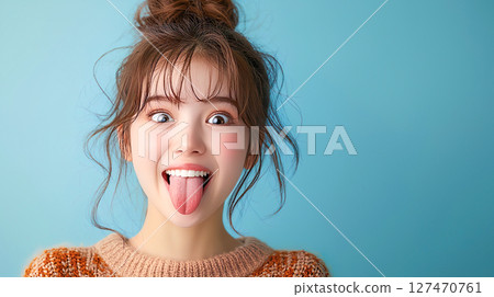 Young woman sticking out her tongue mockingly 127470761