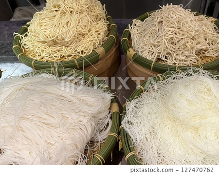 Four types of noodles in a bamboo basket: rice vermicelli, glass noodles, Chinese noodles, and soba Four types of noodles in a bamboo basket: rice vermicelli, glass noodles, Chinese noodles, and soba 127470762