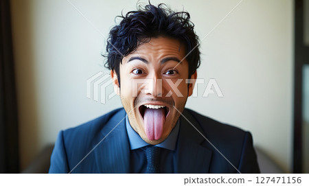 一位西裝革履的商人嘲諷地吐著舌頭 127471156