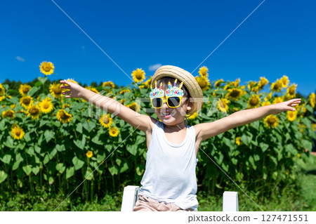 Little boy playing in sunflower field 127471551