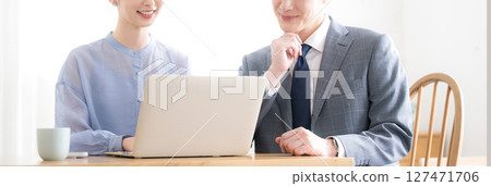 Banner without faces of businessmen and women in suits looking at computers in an office Banner without faces of businessmen and women in suits looking at computers in an office 127471706