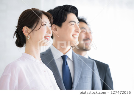 Close-up of three men and women in profile in a business scene looking to the future and goals Image of job change and hope 127472056