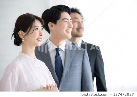 Close-up of three men and women in profile in a business scene looking to the future and goals Image of job change and hope 127472057