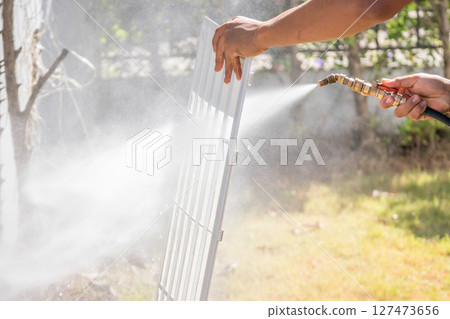 air conditioning filter cleaning with water spray air conditioning filter cleaning with water spray 127473656