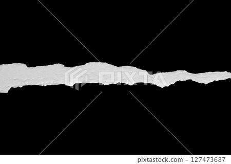 Ripped torn paper edges isolated on black background Ripped torn paper edges isolated on black background 127473687