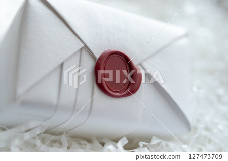 Wax seal stamp on white paper wrap packaging parcel box 127473709