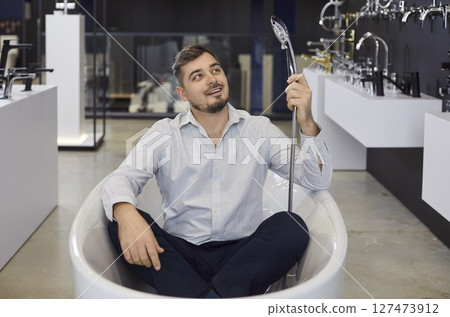 Man Customer Choosing Bathtub In Store With Fun 127473912