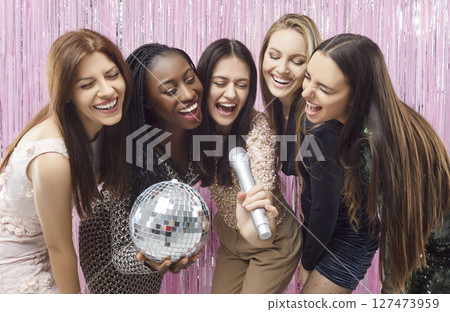 Happy smiling multiracial friends girls karaoke singing, women have fun at hen party at club 127473959