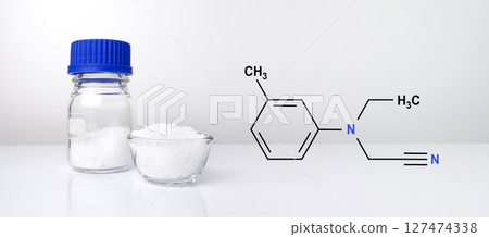 Microcrystalline wax with chemical formula on white laboratory table. 127474338