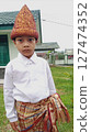 little boy in a kimono shirt and hat 127474352