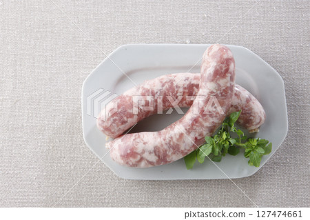 Raw wieners on a plate 127474661