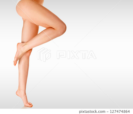 Long woman's legs against a grey background with copyspace Long woman's legs against a grey background with copyspace 127474864