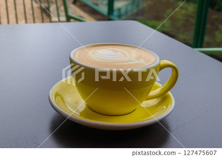 Cup of hot cappuccino coffee on a table 127475607