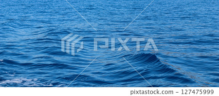 Close-up view of rippling deep blue sea water, showcasing natural patterns and movements on the surface. High quality photo Close-up view of rippling deep blue sea water, showcasing natural patterns and movements on the surface. High quality photo 127475999