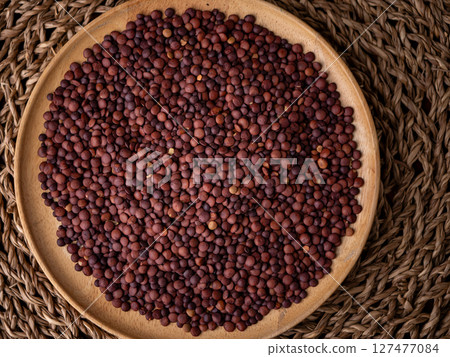 Organic uncooked seeds dark red brown lentils. Organic uncooked seeds dark red brown lentils. 127477084
