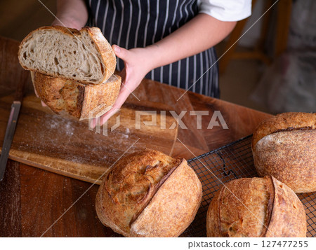 Baker Hand Presenting Homemade Sourdough. 127477255