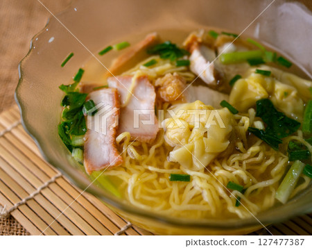egg noodles with wonton roasted pork and crispy pork. 127477387