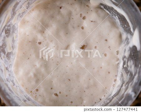 Bubbly sourdough starter in glass jar. Active yeast for bread making 127477441