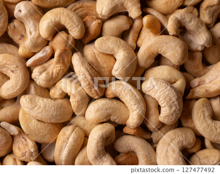 Full frame Cashew nuts background. Vegetarian Organic Healthy snack concept. Full frame Cashew nuts background. Vegetarian Organic Healthy snack concept. 127477492