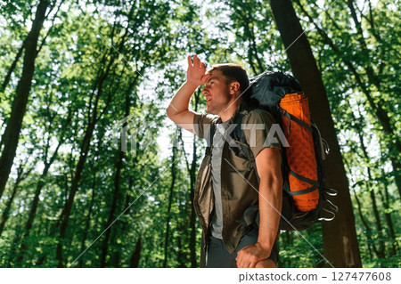 Tired, taking a break. Tourist in summer forest. Conception of exploration and leisure 127477608