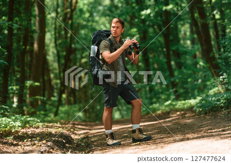 Tourist in summer forest. Conception of exploration and leisure 127477624