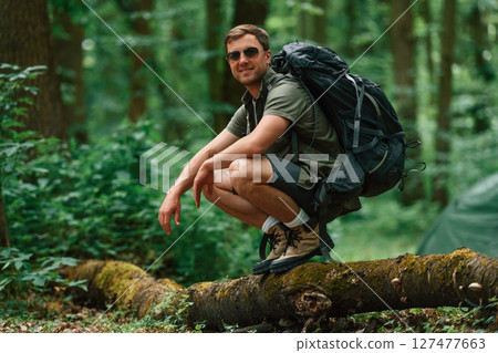 Tourist in summer forest. Conception of exploration and leisure 127477663