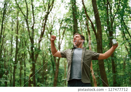 Just woke up, good morning, with cup in hand. Tourist in summer forest. Conception of exploration and leisure 127477712