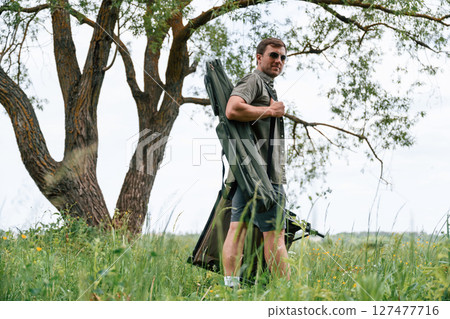 Tourist is outdoors near the lake. Conception of exploration and leisure 127477716