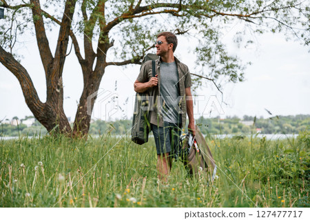 Tourist is outdoors near the lake. Conception of exploration and leisure 127477717