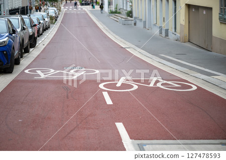 Dedicated bike lane on red asphalt road, promoting eco transport Dedicated bike lane on red asphalt road, promoting eco transport 127478593