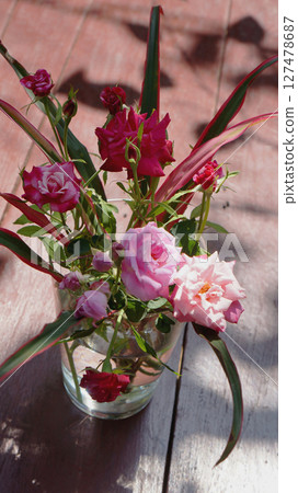 Pink and Red Roses in a Glass Vase 127478687