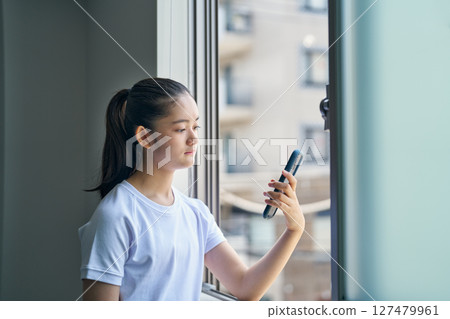 A girl looking at her smartphone during physical education class 127479961