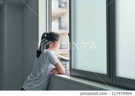 A girl looking outside during gym class 127479964