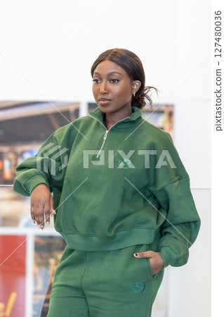 A stunning model in stylish green athletic wear that effortlessly captures attention A stunning model in stylish green athletic wear that effortlessly captures attention 127480036
