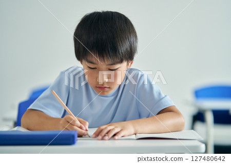 A boy studying hard A boy studying hard 127480642