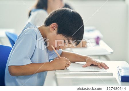 A boy studying hard A boy studying hard 127480644