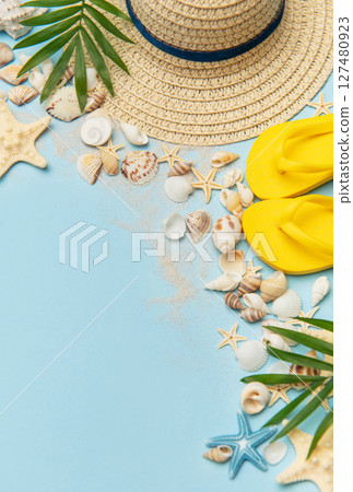 Beach accessories creating summer holiday mood on blue background 127480923