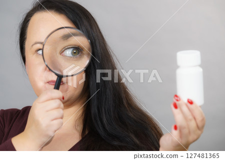 Woman investigating ingredients of medicines Woman investigating ingredients of medicines 127481365